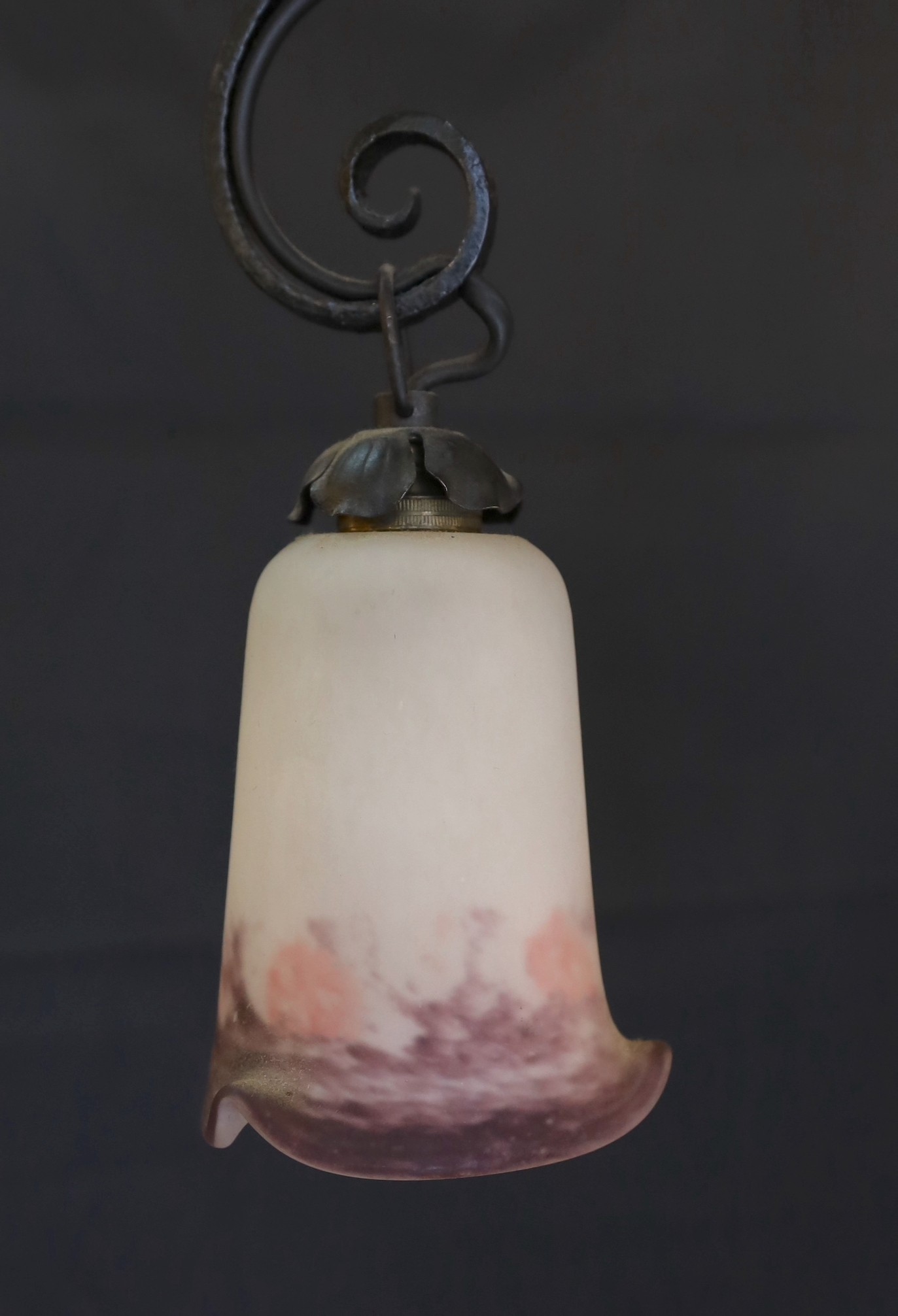 A 1920s French wrought iron three branch light fitting with marbled and frosted glass shades, height 74cm. width 43cm